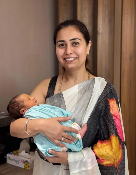 Delighted parents holding their bundle of joy