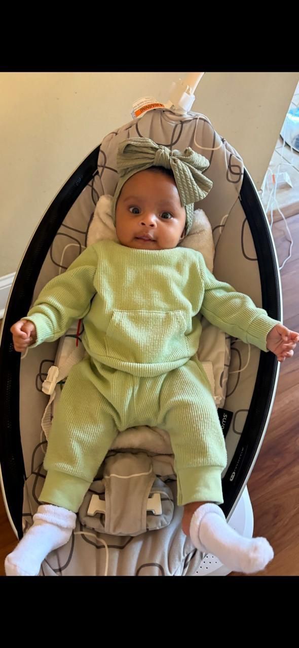 Happy baby dressed in green